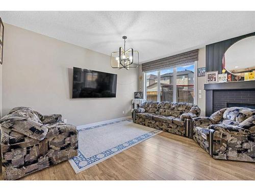244 Cornerbrook Common Ne, Calgary, AB - Indoor Photo Showing Living Room With Fireplace