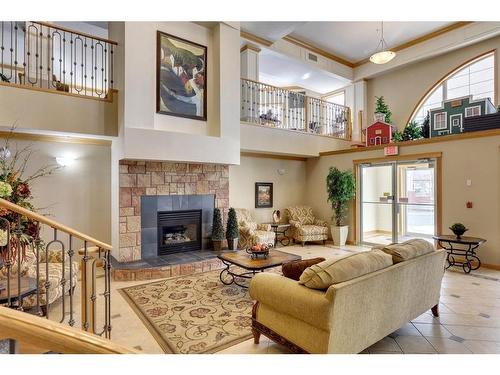 295-223 Tuscany Springs Boulevard Nw, Calgary, AB - Indoor With Fireplace