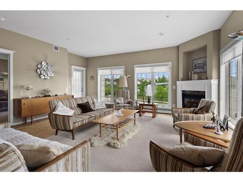 295-223 Tuscany Springs Boulevard Nw, Calgary, AB - Indoor Photo Showing Living Room With Fireplace