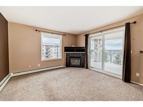 1419-16320 24 Street Sw, Calgary, AB - Indoor Photo Showing Living Room With Fireplace