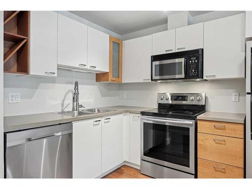 130-315 24 Avenue Sw, Calgary, AB - Indoor Photo Showing Kitchen With Stainless Steel Kitchen With Double Sink