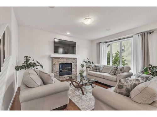 16 Masters Way Se, Calgary, AB - Indoor Photo Showing Living Room With Fireplace