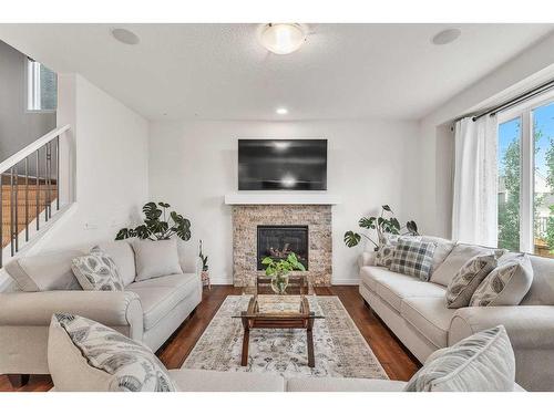 16 Masters Way Se, Calgary, AB - Indoor Photo Showing Living Room With Fireplace