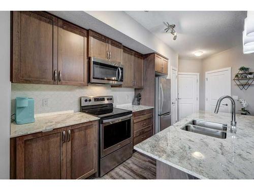 2210-3727 Sage Hill Drive Nw, Calgary, AB - Indoor Photo Showing Kitchen With Double Sink With Upgraded Kitchen