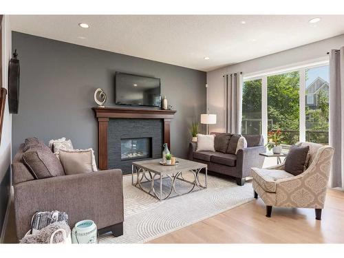 1177 Coopers Drive Sw, Airdrie, AB - Indoor Photo Showing Living Room With Fireplace