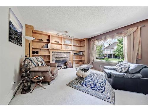 66 Tuscany Hills Point Nw, Calgary, AB - Indoor Photo Showing Living Room With Fireplace