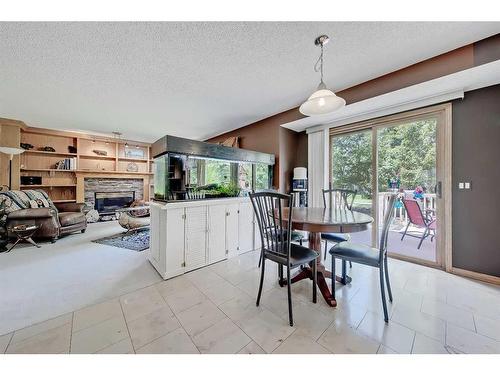 66 Tuscany Hills Point Nw, Calgary, AB - Indoor Photo Showing Dining Room With Fireplace