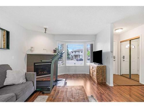 45 Patina Park Sw, Calgary, AB - Indoor Photo Showing Other Room With Fireplace