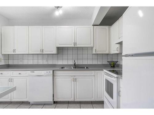 45 Patina Park Sw, Calgary, AB - Indoor Photo Showing Kitchen With Double Sink