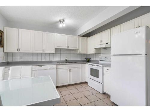 45 Patina Park Sw, Calgary, AB - Indoor Photo Showing Kitchen With Double Sink
