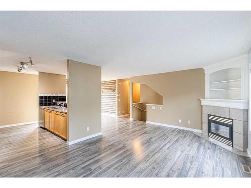 128 Country Village Cape Ne, Calgary, AB - Indoor Photo Showing Other Room With Fireplace