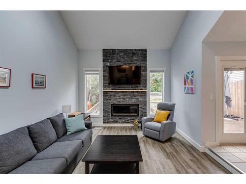 7828 Ranchview Drive Nw, Calgary, AB - Indoor Photo Showing Living Room With Fireplace