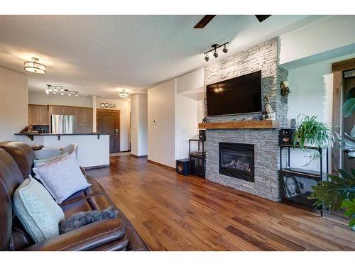 527-10 Discovery Ridge Close Sw, Calgary, AB - Indoor Photo Showing Living Room With Fireplace