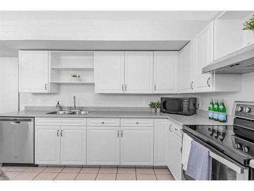 323-4525 31 Street Sw, Calgary, AB - Indoor Photo Showing Kitchen With Stainless Steel Kitchen With Double Sink