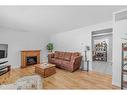 323-4525 31 Street Sw, Calgary, AB  - Indoor Photo Showing Living Room With Fireplace 