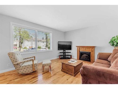 323-4525 31 Street Sw, Calgary, AB - Indoor Photo Showing Living Room With Fireplace