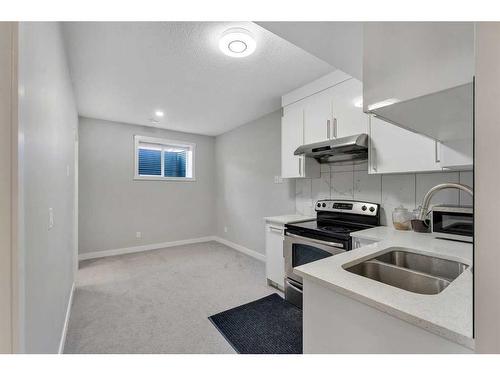 24 Saddlestone Way, Calgary, AB - Indoor Photo Showing Kitchen With Double Sink