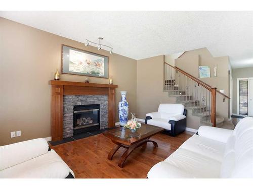 74 Elgin Park Road Se, Calgary, AB - Indoor Photo Showing Living Room With Fireplace