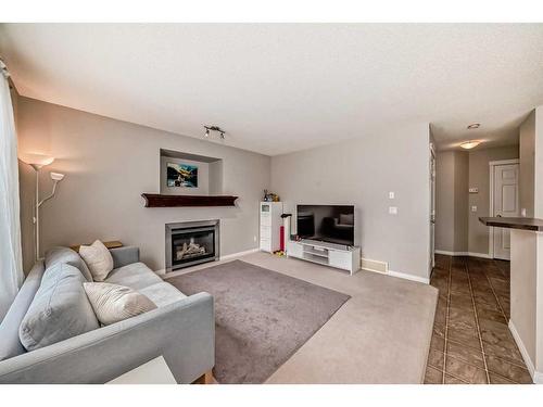 109 Cougar Plateau Mews Sw, Calgary, AB - Indoor Photo Showing Living Room With Fireplace