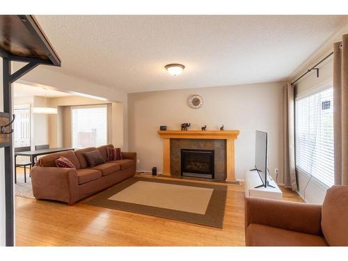 143 Copperfield Rise Se, Calgary, AB - Indoor Photo Showing Living Room With Fireplace