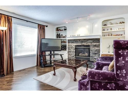 226 Sienna Park Gardens Sw, Calgary, AB - Indoor Photo Showing Living Room With Fireplace
