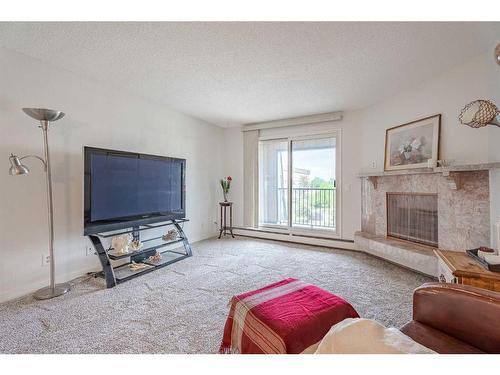 1307-4001A 49 Street Nw, Calgary, AB - Indoor Photo Showing Living Room With Fireplace