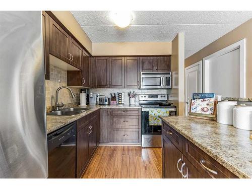 905-2200 Woodview Drive Sw, Calgary, AB - Indoor Photo Showing Kitchen With Stainless Steel Kitchen With Double Sink