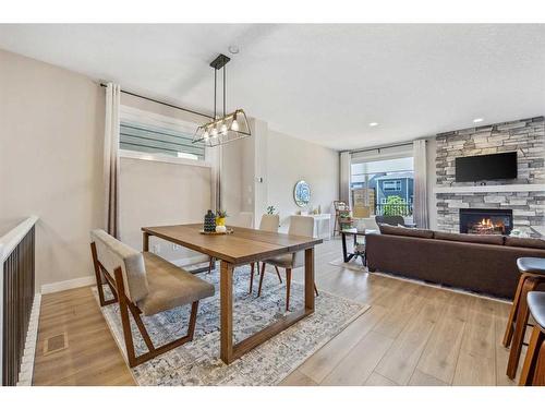 13 Cranbrook Close Se, Calgary, AB - Indoor Photo Showing Dining Room With Fireplace