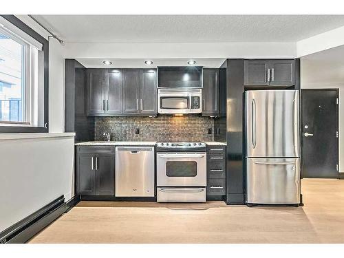 103-1815 16 Street Sw, Calgary, AB - Indoor Photo Showing Kitchen With Stainless Steel Kitchen With Upgraded Kitchen