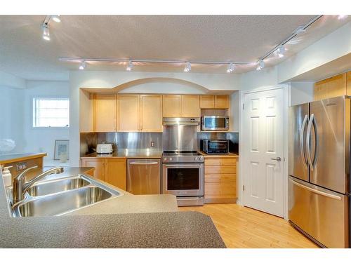 253 River Rock Place Se, Calgary, AB - Indoor Photo Showing Kitchen With Double Sink