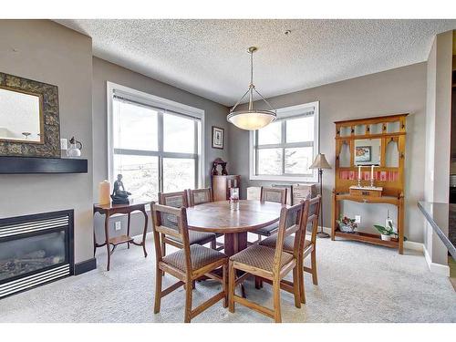 318-88 Arbour Lake Road Nw, Calgary, AB - Indoor Photo Showing Dining Room With Fireplace