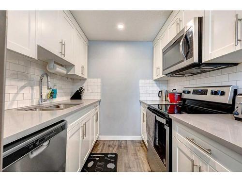 706-9930 Bonaventure Drive Se, Calgary, AB - Indoor Photo Showing Kitchen With Stainless Steel Kitchen With Double Sink