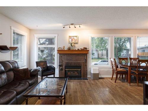 424 Pinegreen Close Ne, Calgary, AB - Indoor Photo Showing Living Room With Fireplace
