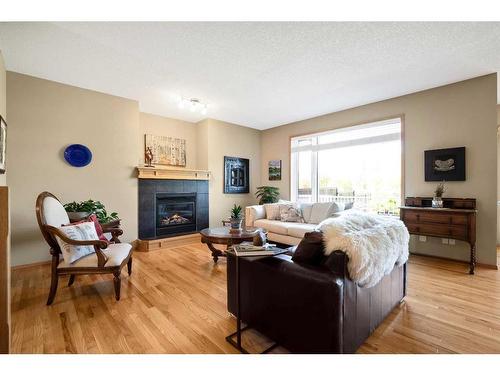 438 Silverado Boulevard Sw, Calgary, AB - Indoor Photo Showing Living Room With Fireplace