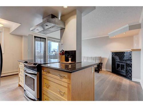 703-1225 15 Avenue Sw, Calgary, AB - Indoor Photo Showing Kitchen With Fireplace
