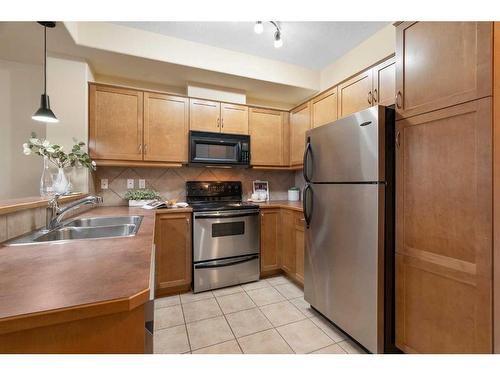 410-208 Holy Cross Sw, Calgary, AB - Indoor Photo Showing Kitchen With Double Sink