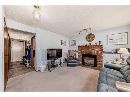 84 Deersaxon Circle Se, Calgary, AB - Indoor Photo Showing Living Room With Fireplace