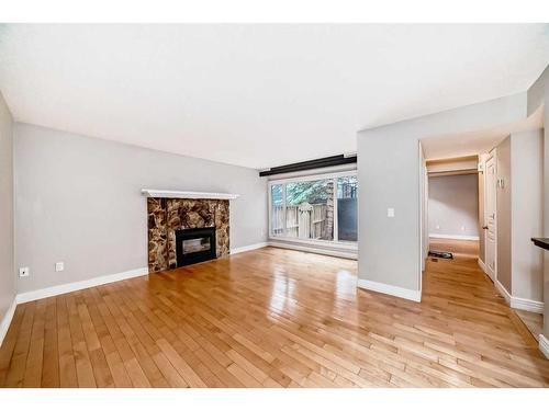 114-34 Glamis Green Sw, Calgary, AB - Indoor Photo Showing Living Room With Fireplace