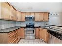 114-34 Glamis Green Sw, Calgary, AB  - Indoor Photo Showing Kitchen With Double Sink 