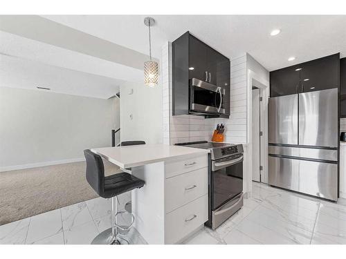 209-13104 Elbow Drive Sw, Calgary, AB - Indoor Photo Showing Kitchen With Stainless Steel Kitchen