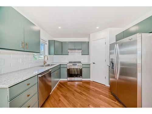 90 Rocky Ridge Drive Nw, Calgary, AB - Indoor Photo Showing Kitchen With Double Sink With Upgraded Kitchen