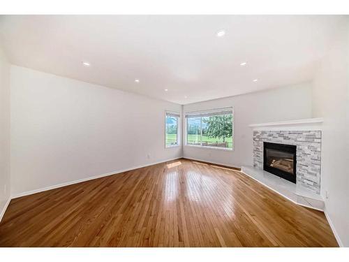 90 Rocky Ridge Drive Nw, Calgary, AB - Indoor Photo Showing Other Room With Fireplace