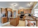 38 Crystal Shores Heights, Okotoks, AB  - Indoor Photo Showing Kitchen With Double Sink 