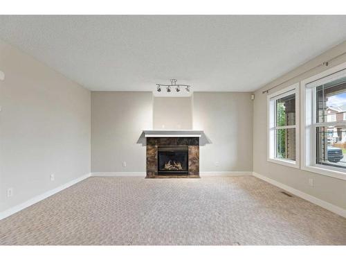 27 Saddlebrook Gardens Ne, Calgary, AB - Indoor Photo Showing Living Room With Fireplace