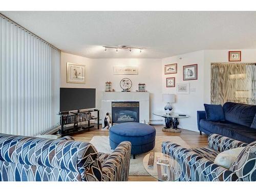 210-804 3 Avenue Sw, Calgary, AB - Indoor Photo Showing Living Room With Fireplace