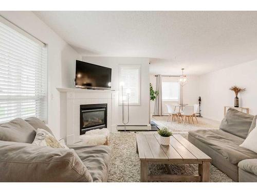 119-260 Shawville Way Se, Calgary, AB - Indoor Photo Showing Living Room With Fireplace