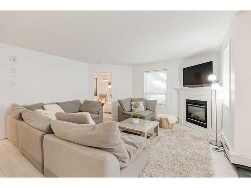 119-260 Shawville Way Se, Calgary, AB - Indoor Photo Showing Living Room With Fireplace