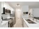 119-260 Shawville Way Se, Calgary, AB  - Indoor Photo Showing Kitchen With Stainless Steel Kitchen With Double Sink With Upgraded Kitchen 