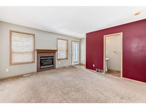 355 Eversyde Boulevard Sw, Calgary, AB - Indoor Photo Showing Living Room With Fireplace