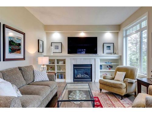 18 Discovery Woods Villas Sw, Calgary, AB - Indoor Photo Showing Living Room With Fireplace